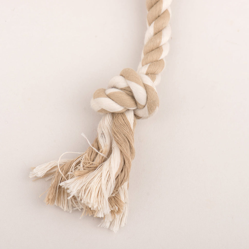 Beige rope tug dog toy with knotted end and fringe tassels