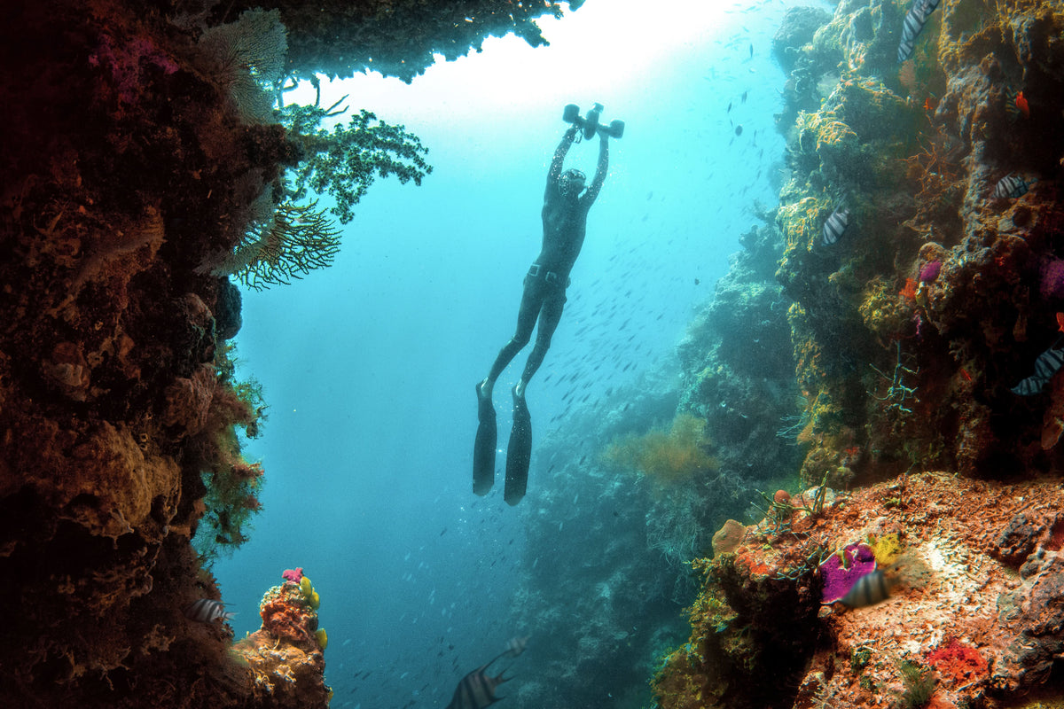 Diver wearing scuba gear with hands-free underwater camera system