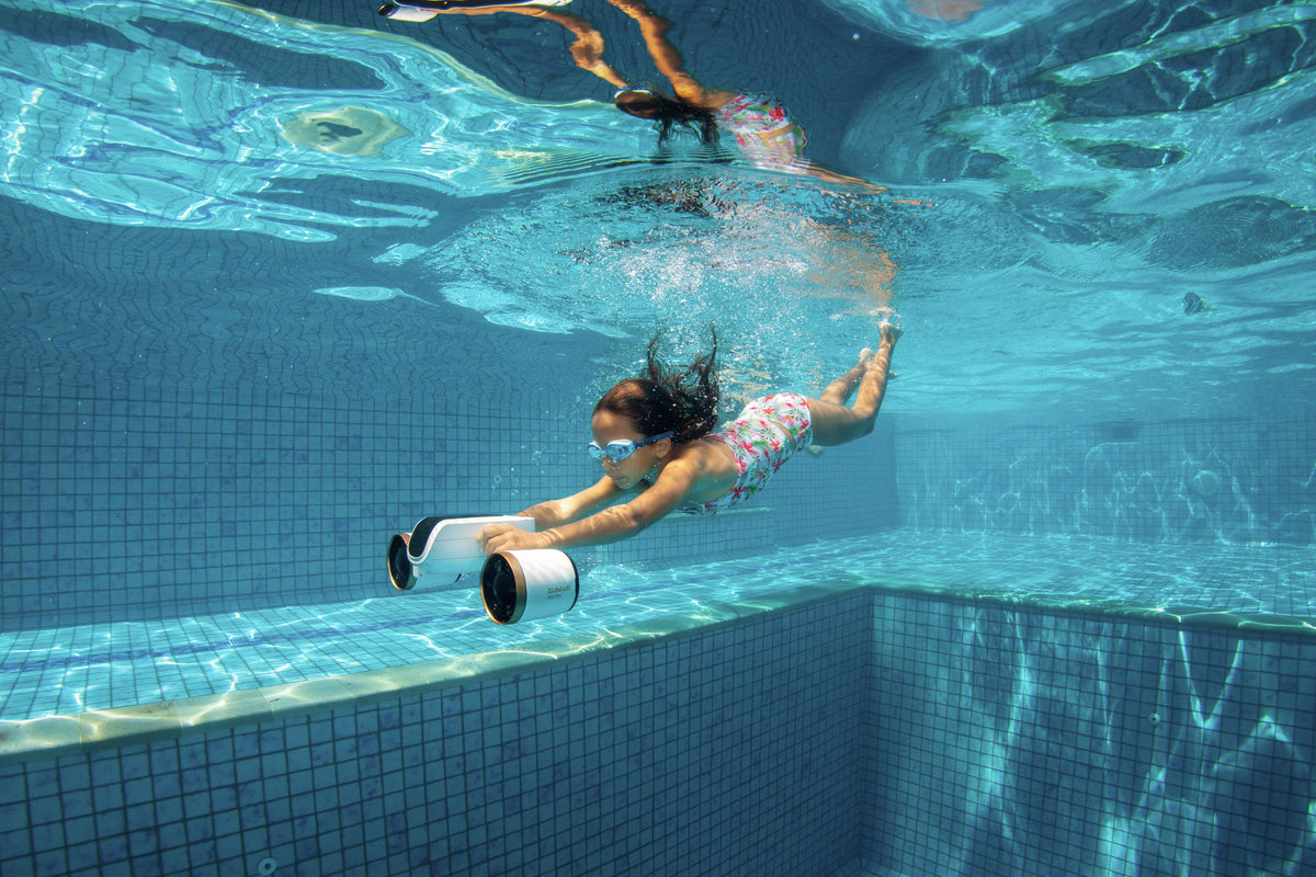 Underwater diver with hands-free white camera housing and black mount