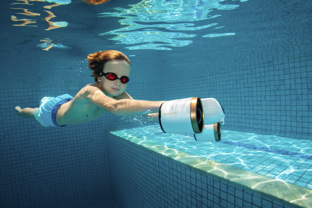 Diver using a submerged white-and-blue underwater camera attachment