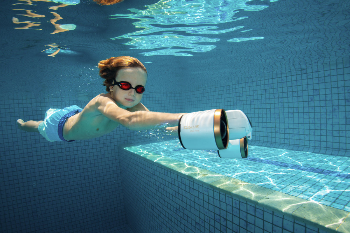 Diver using a submerged white-and-blue underwater camera attachment
