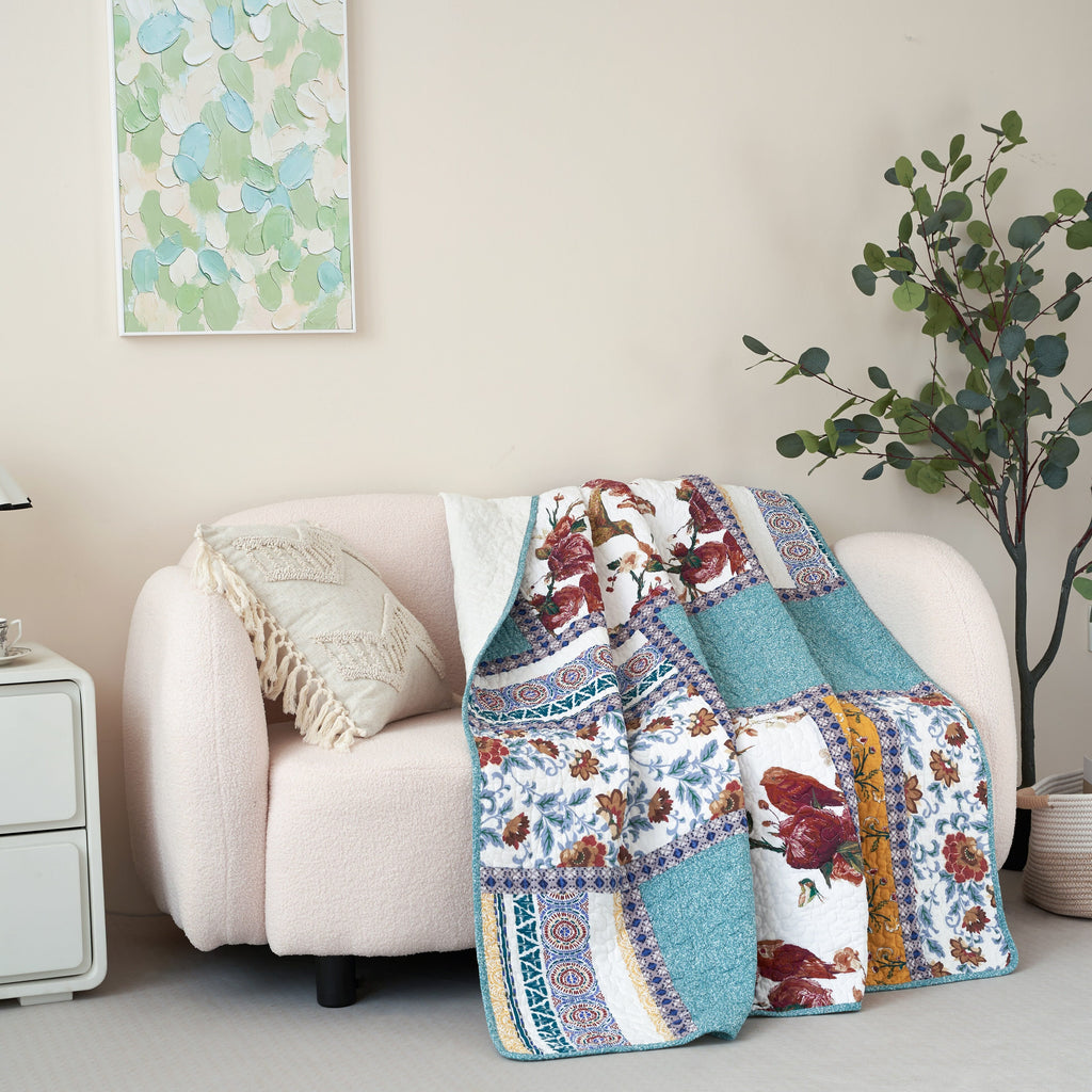 Quilted patchwork throw blanket with multicolor patch strips, blue ground, and floral bird imagery