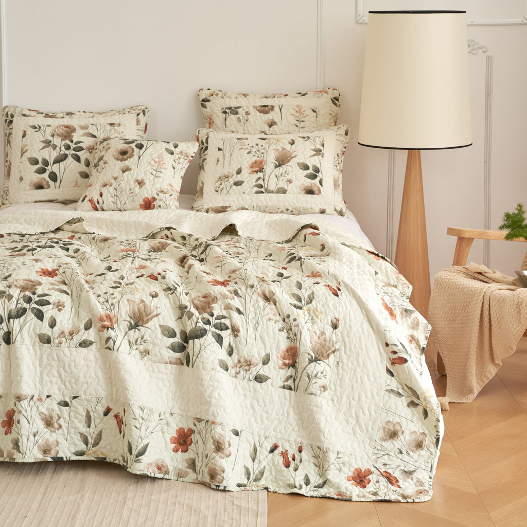 Cream floral quilt set with coordinating pillow shams and quilted bedspread