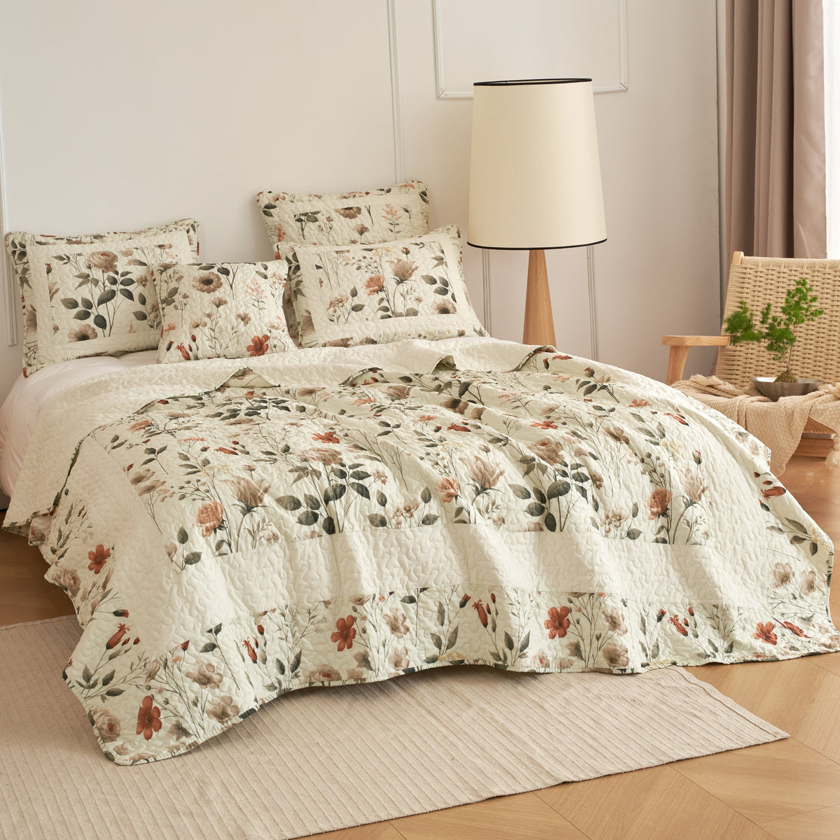 Cream floral quilt set with beige and green botanical print over the quilted bedspread