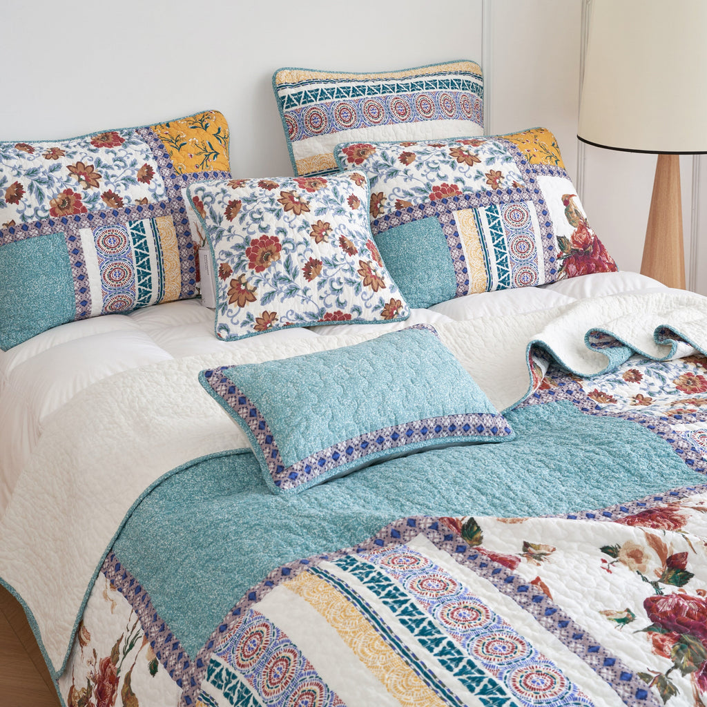 Turquoise lumbar pillow sham with patchwork border, styled on a bed
