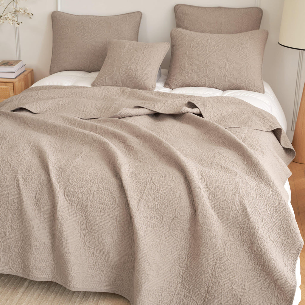 Taupe beige quilted bedspread with swirled matelasse pattern and matching pillows