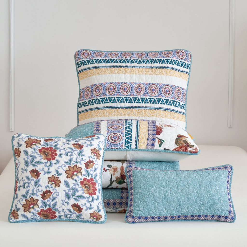 Turquoise lumbar pillow sham with blue patchwork border, shown with coordinating pillows