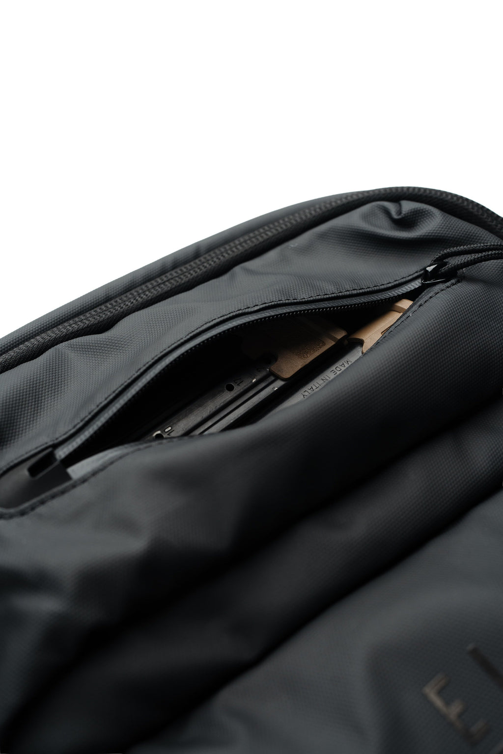 SBR backpack interior close-up with zippered storage and rows of secured tactical parts