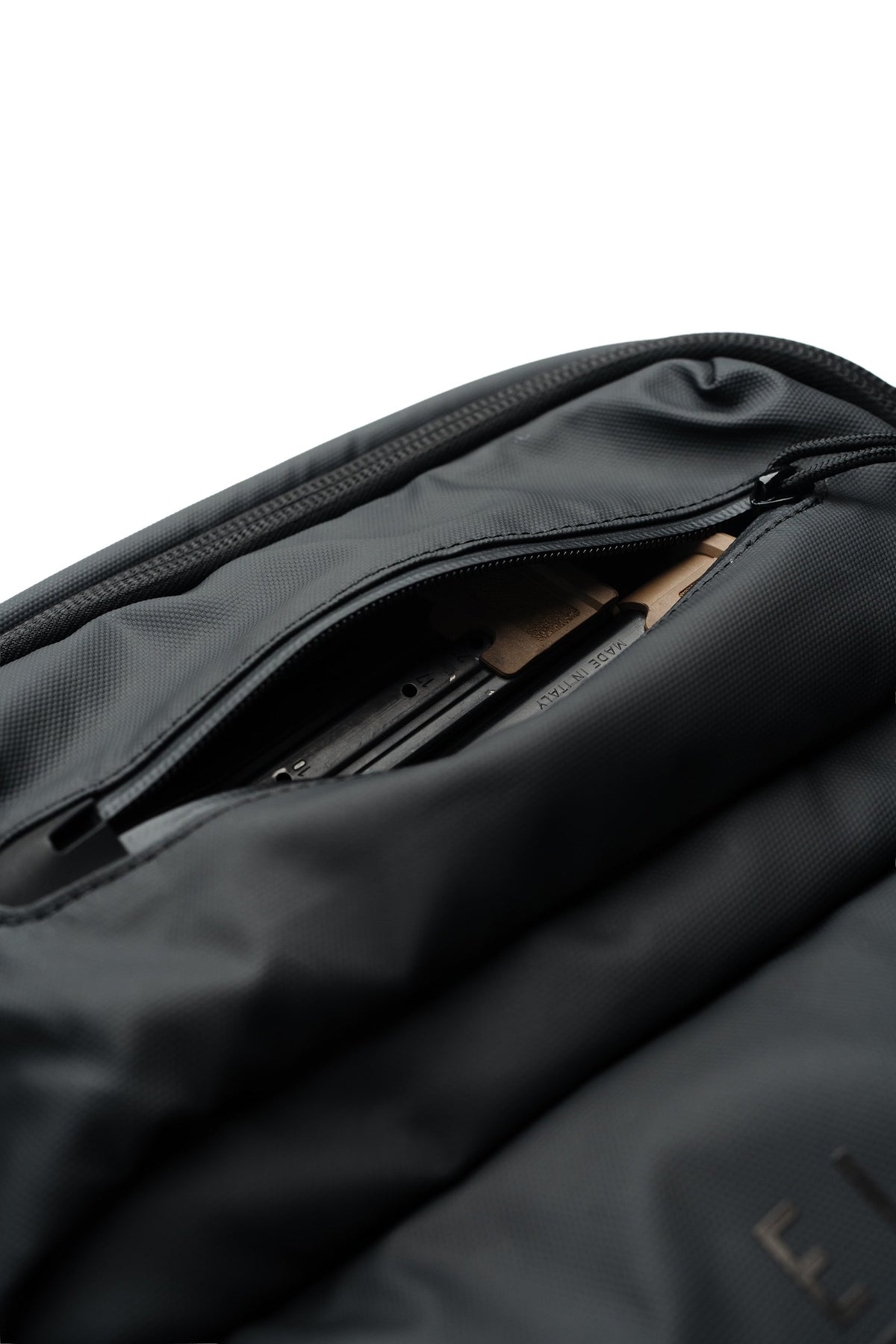 SBR backpack interior close-up with zippered storage and rows of secured tactical parts