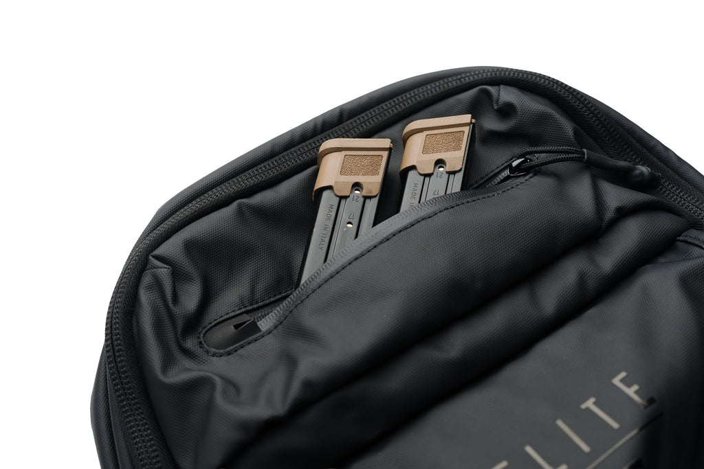 SBR backpack open top section with textured zipper edge and tan-tipped storage pieces