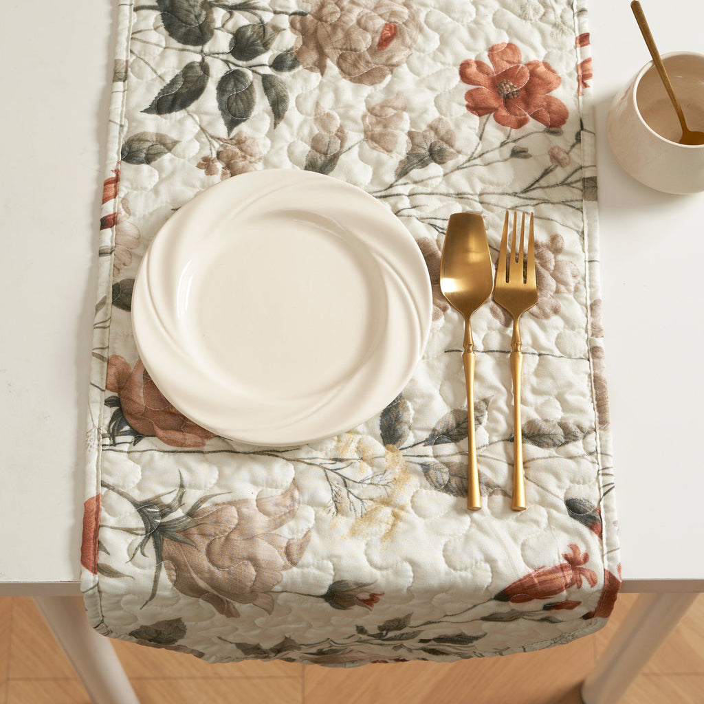 Quilted dinner table runner on table, beige floral print with rose and olive-green leaves