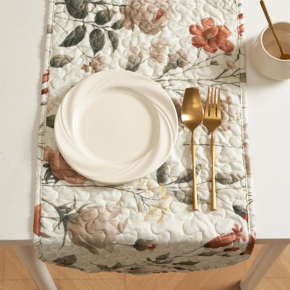 Quilted dinner table runner on table, beige floral print with rose and olive-green leaves