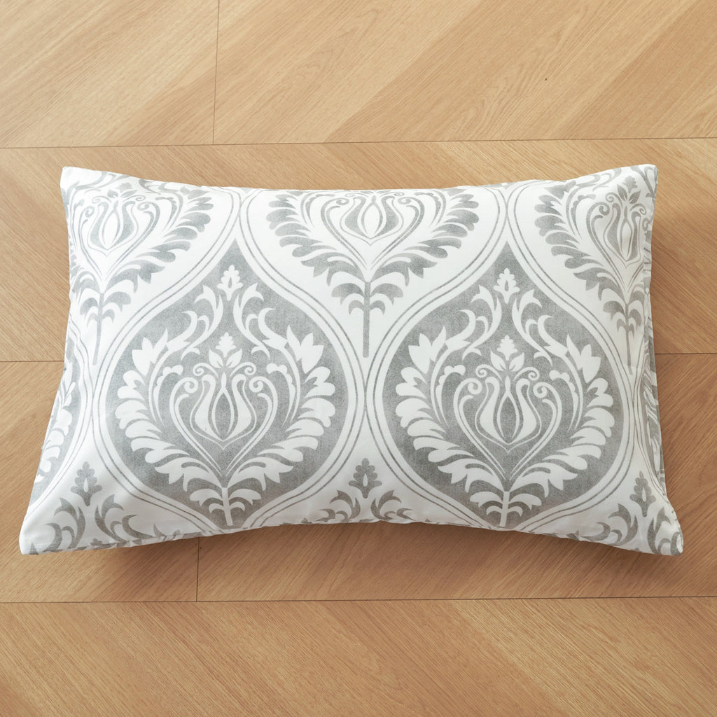 Gray and white damask ogee-pattern rectangular pillowcase on wood floor