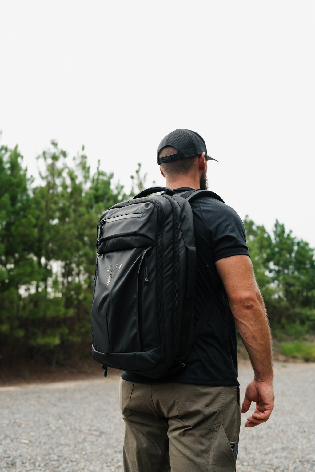Back of dark backpack with padded shoulder straps and top handle