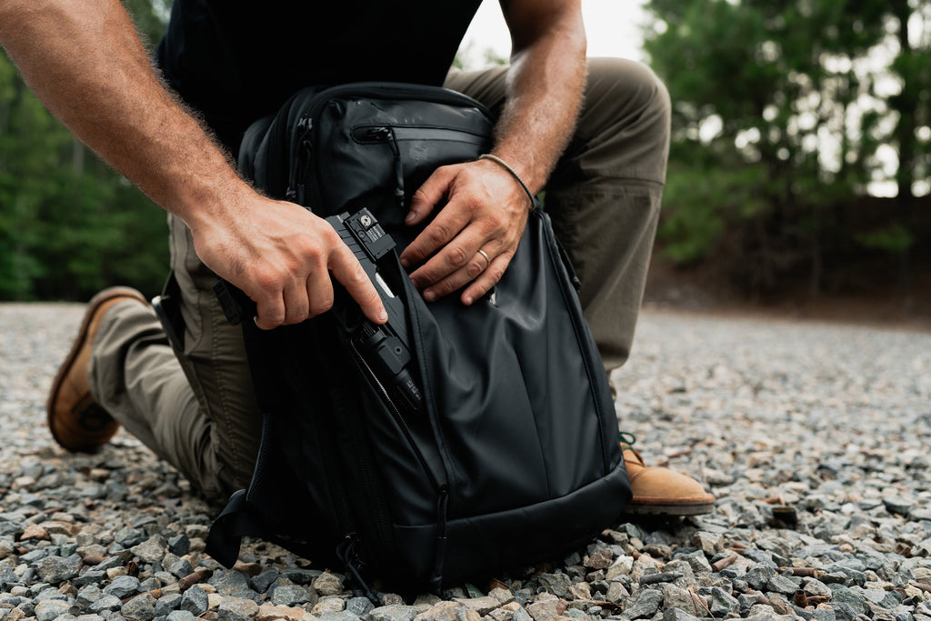 SBR backpack kneeling view, open front access panel and tactical insert inside