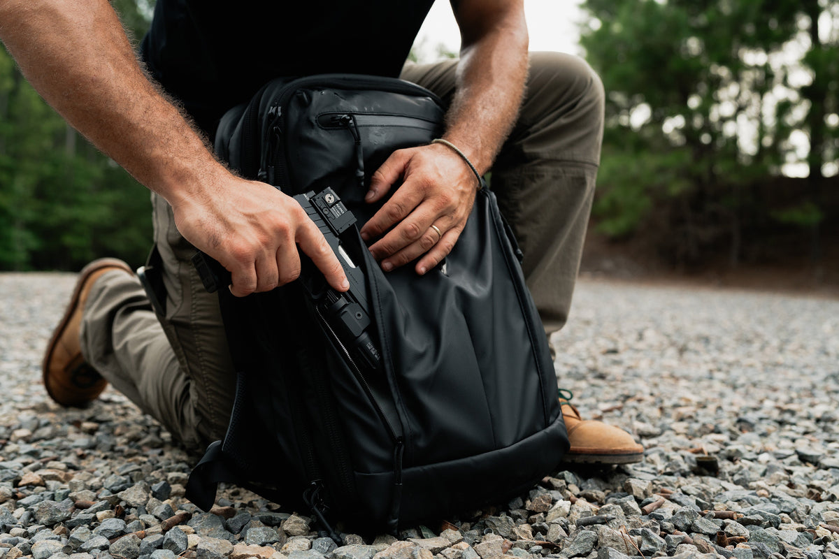 SBR backpack kneeling view, open front access panel and tactical insert inside