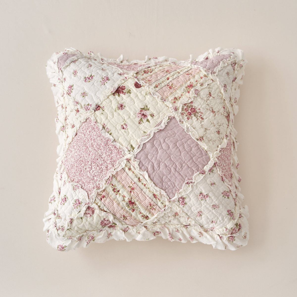Blush quilted floral patchwork pillow cover with ruffled edges and heart seam detail