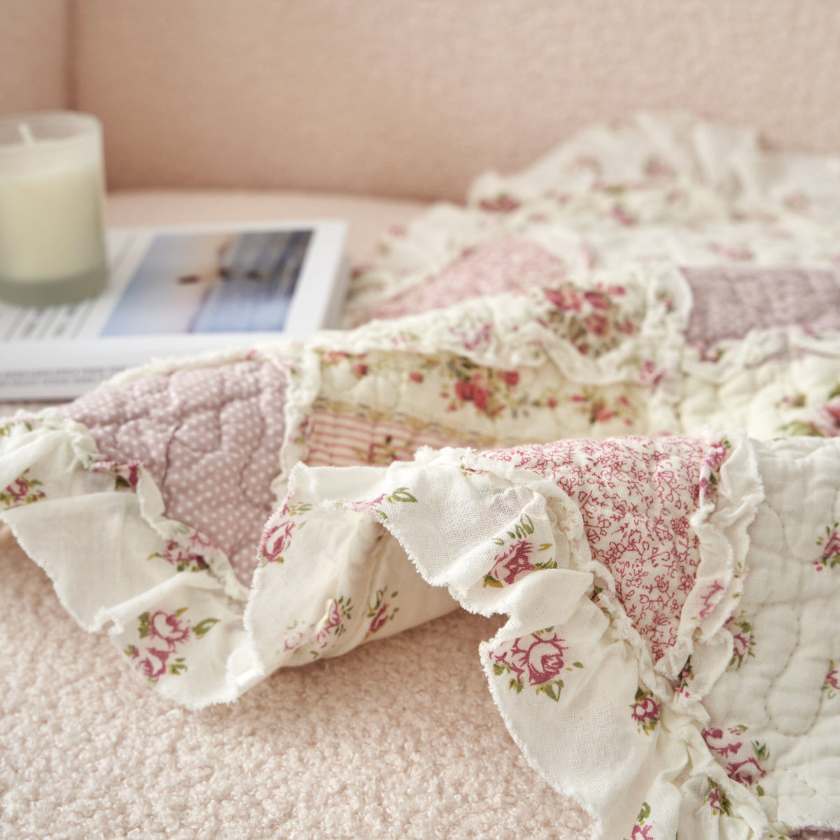 Side view of quilted floral patchwork pillow cover with ruffled trim