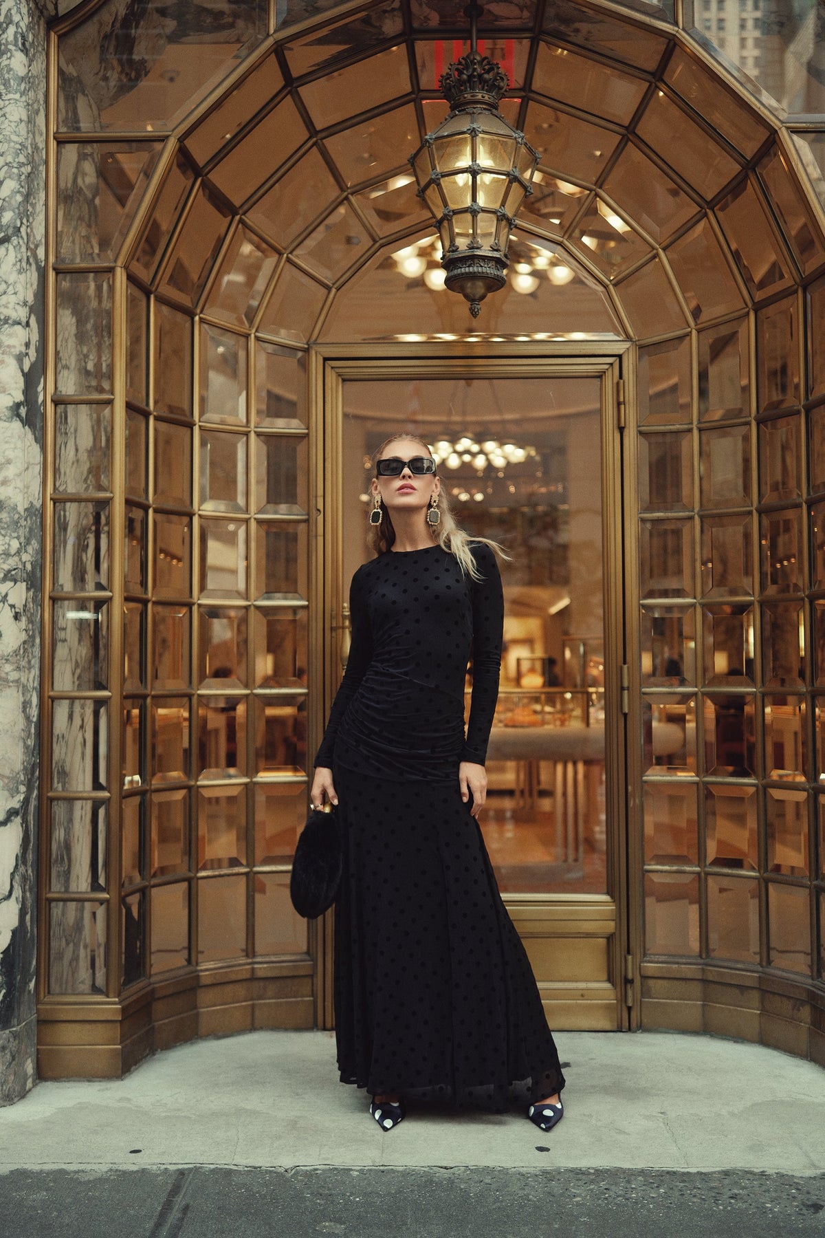 Black mesh dot maxi dress with long sleeves and ruched detailing, full-length standing