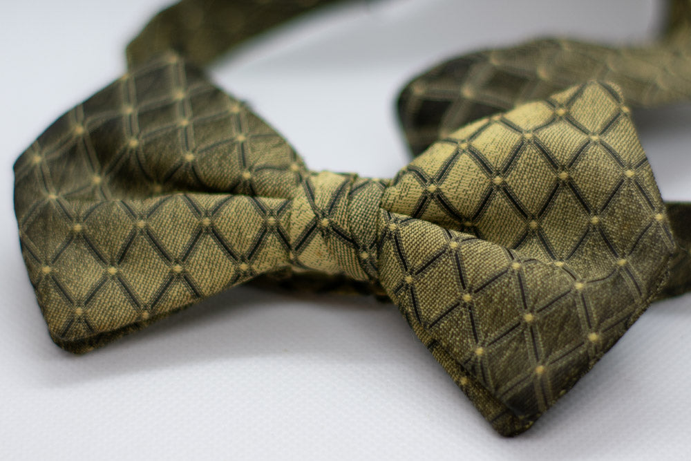 Adjustable formal bow tie in dark olive green with gold geometric check pattern