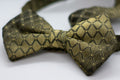 Adjustable formal bow tie in dark olive green with gold geometric check pattern