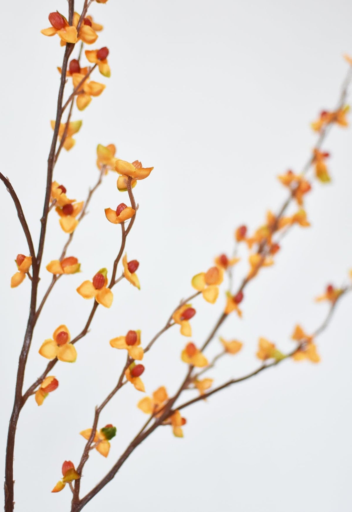 Faux bittersweet stem detail with orange and yellow faux berries