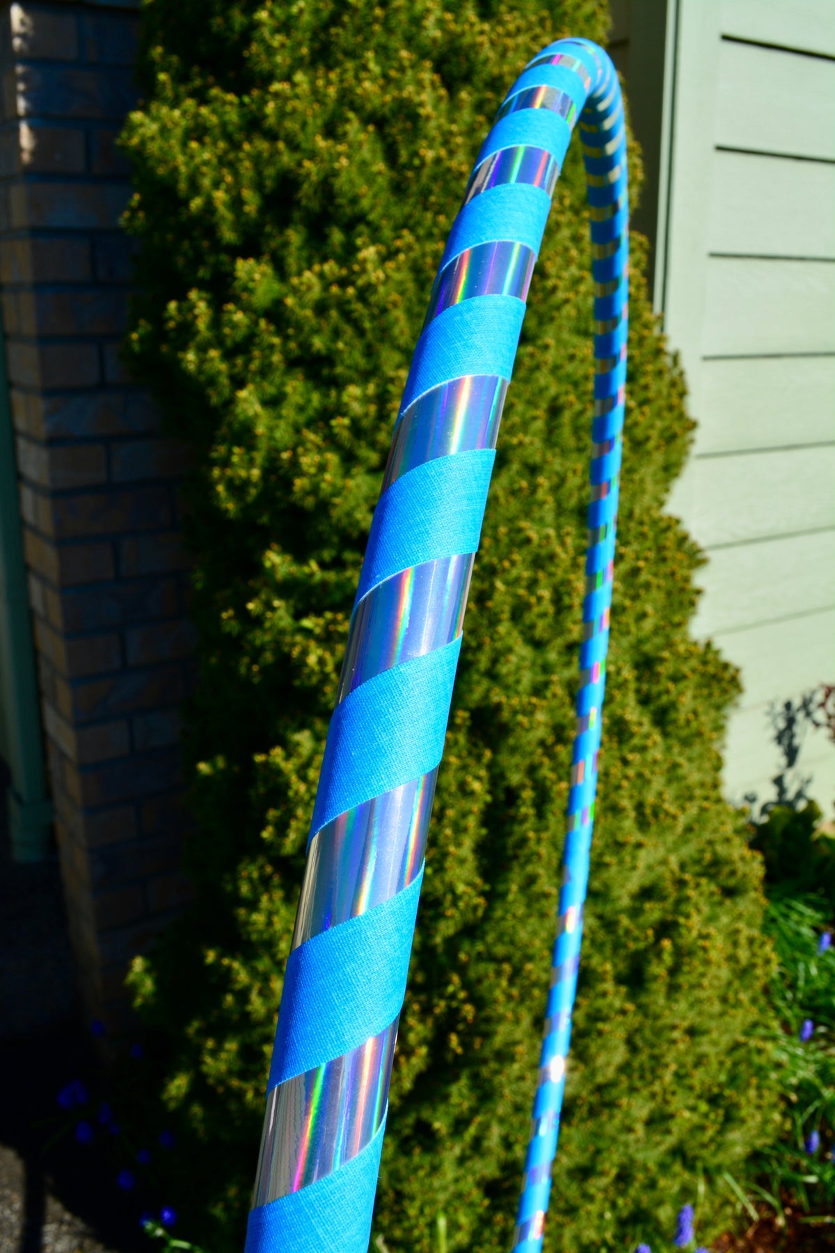 Blue weighted hula hoop with holographic stripe tape wrap and bright tape segments