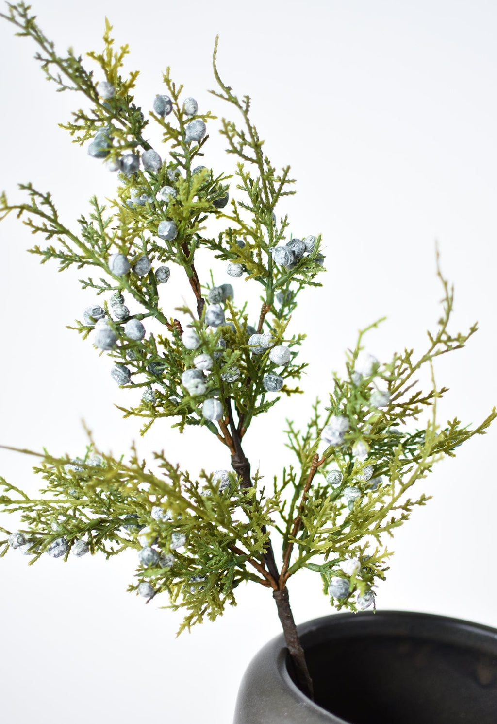 Faux juniper greenery stem with scattered silver berries and leafy twig growth
