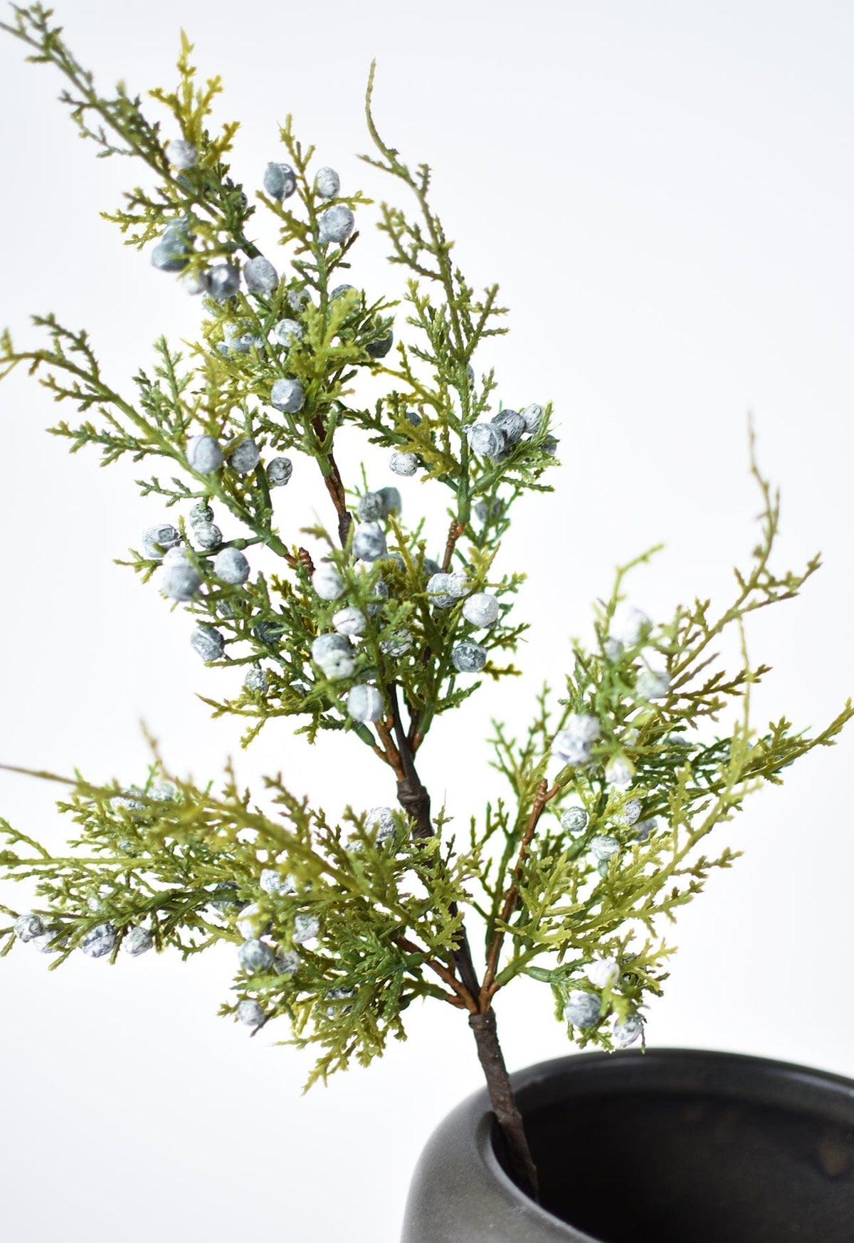 Faux juniper greenery stem with scattered silver berries and leafy twig growth