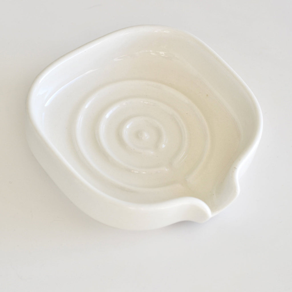 White glossy porcelain soap dish with raised drain base and curved side rests