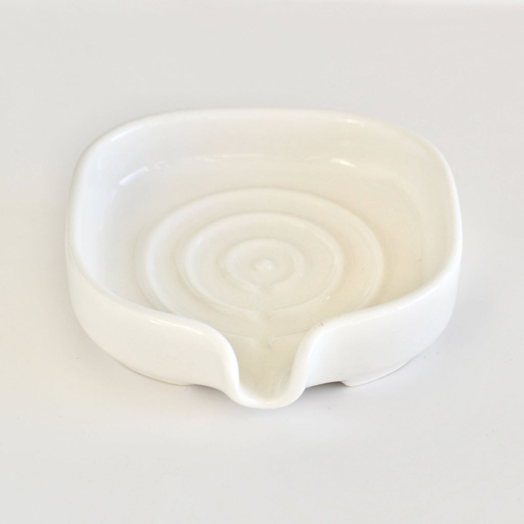 White glossy porcelain soap dish with shallow bowl and front spout