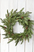 Green faux spruce wreath with clustered faux pinecones
