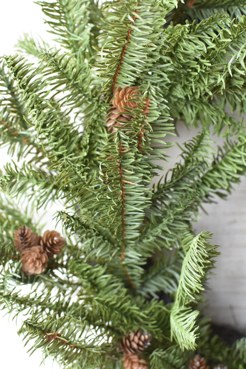 Faux spruce wreath branch with small pinecone accents