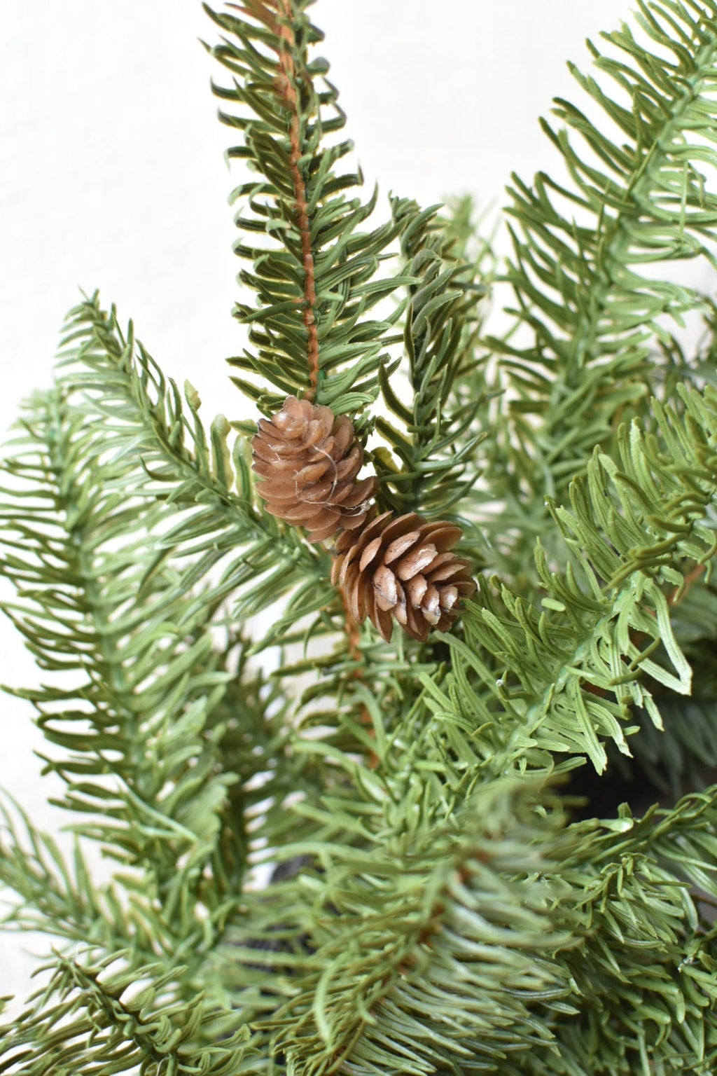 Faux spruce wreath with large faux pinecone centerpiece