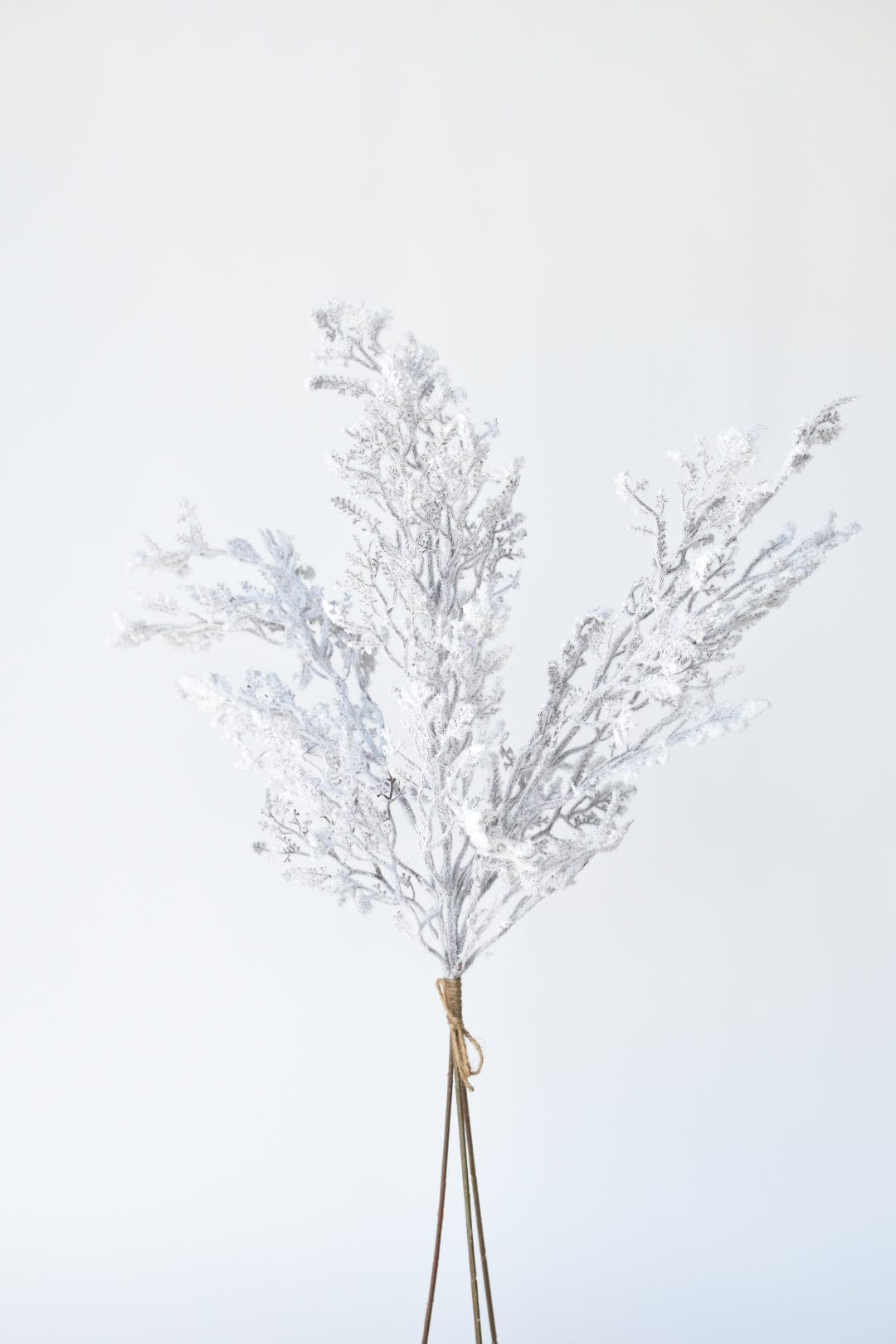 Faux flocked twig bundle with three stems of white-silver frosted twigs