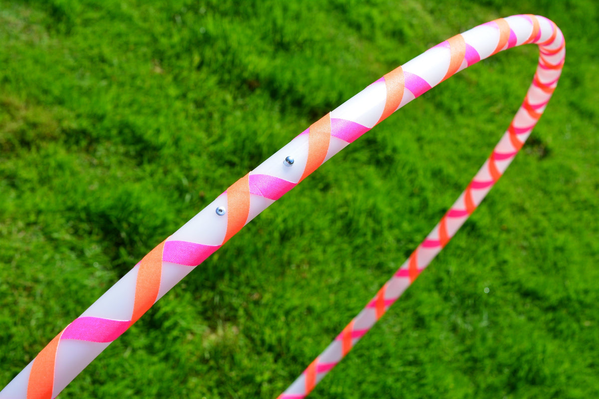 Beginner hula hoop close-up with pink, orange, and white striped gaffer tape