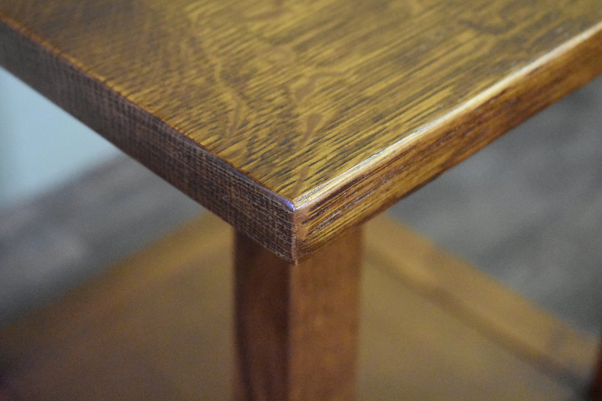 Close-up of wood corner and edge on taboret end table top with visible grain.