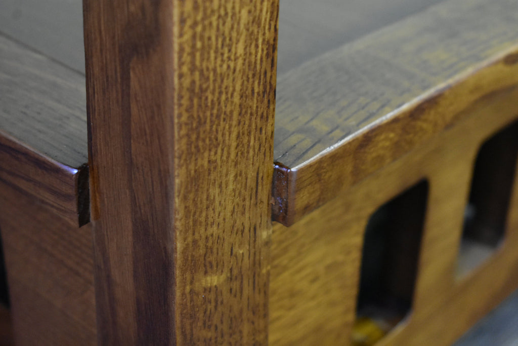 Close-up of taboret end table corner post with carved trim and side cutout opening.