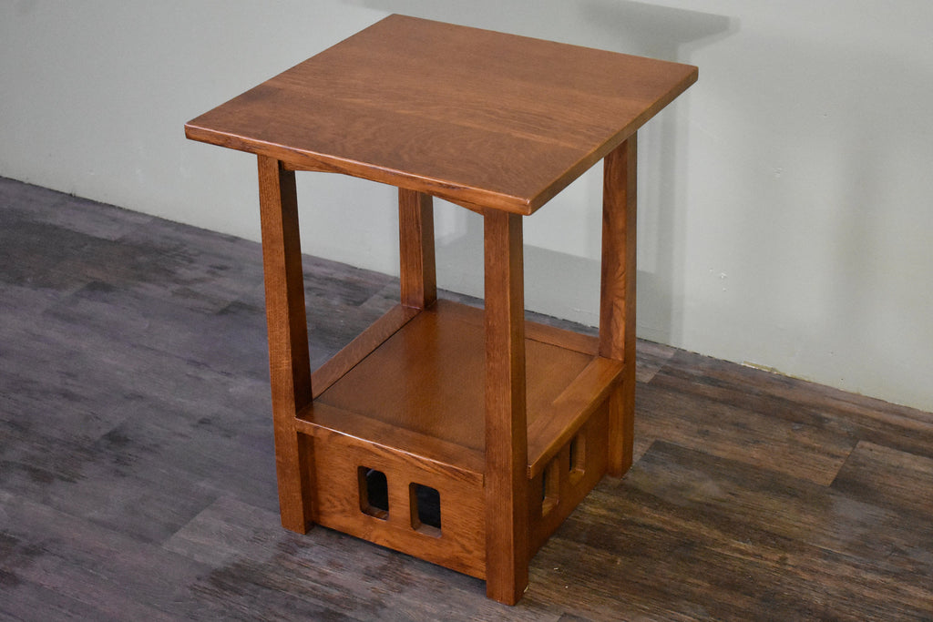 Wood taboret end table with square top, lower open shelf, and two cutout side panels.