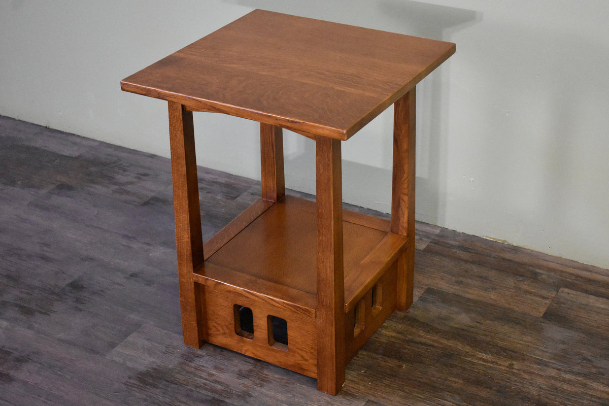 Wood taboret end table with square top, lower open shelf, and two cutout side panels.