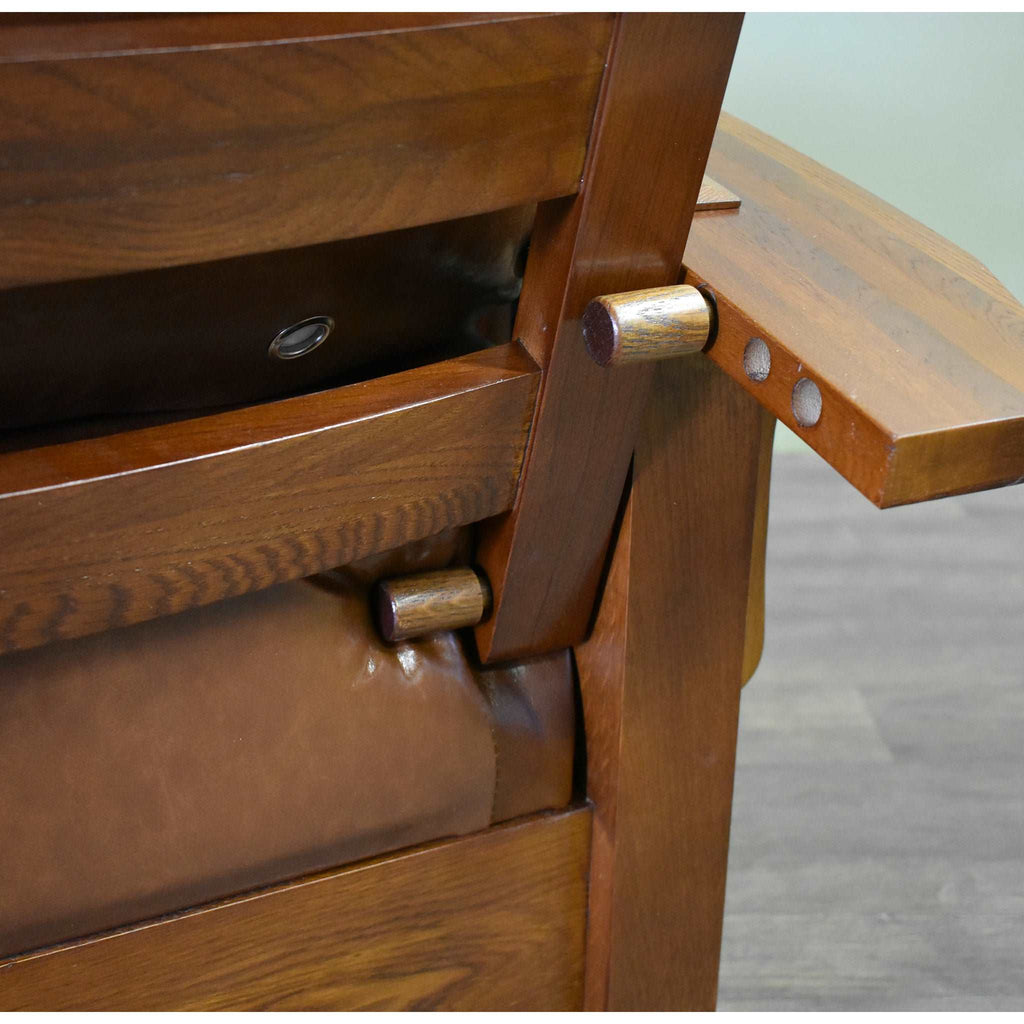 Arm chair corner hardware and brown leather-look seat cushion detail