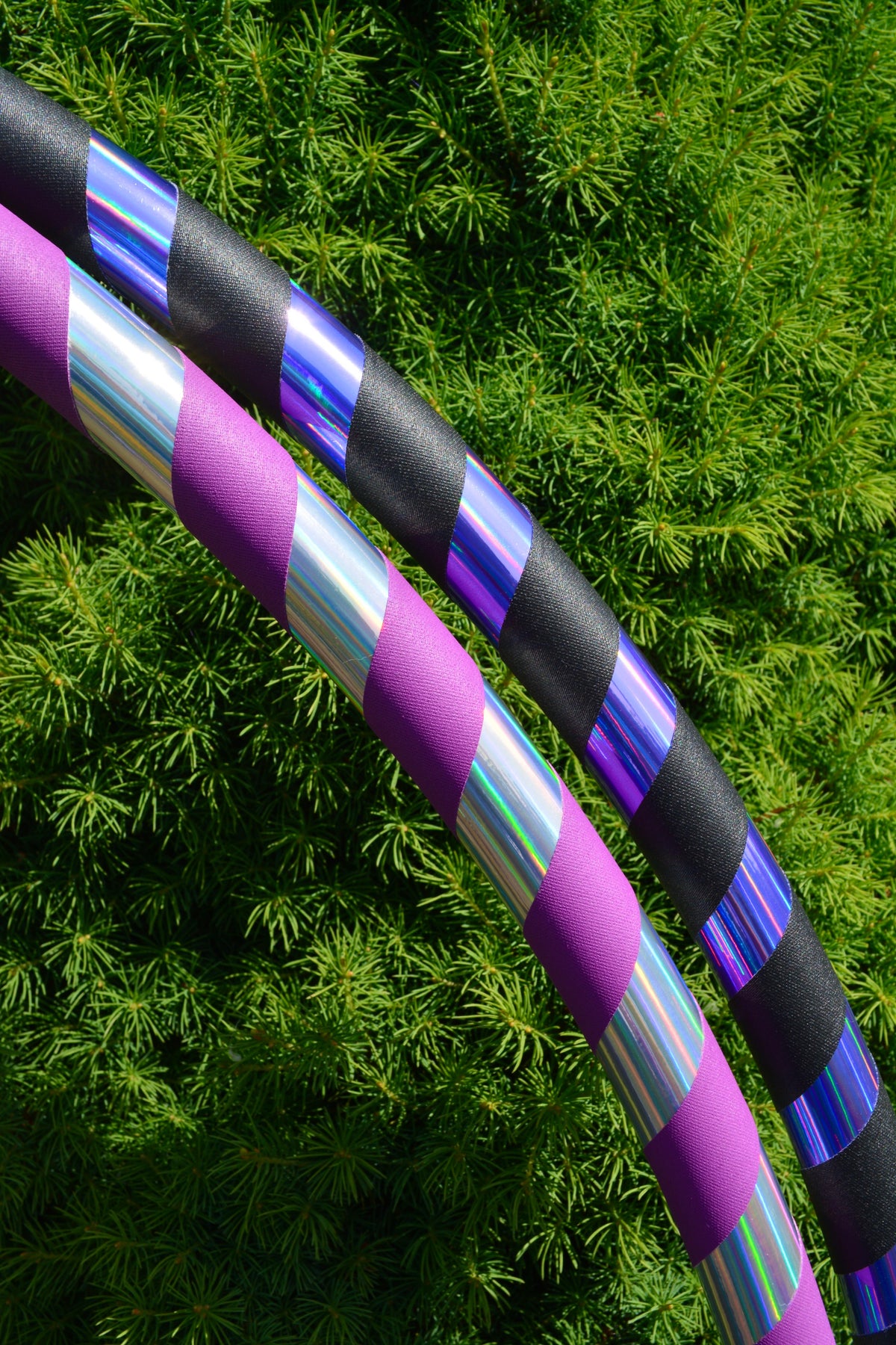 Black-grip holographic hula hoop with purple and silver striped tape sections