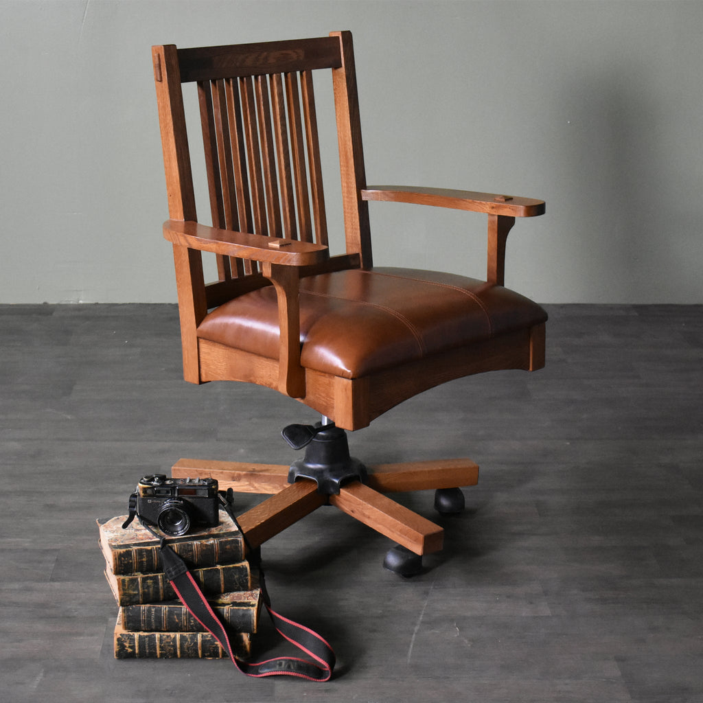 Wood office chair with slat back, padded seat, and dark swivel base