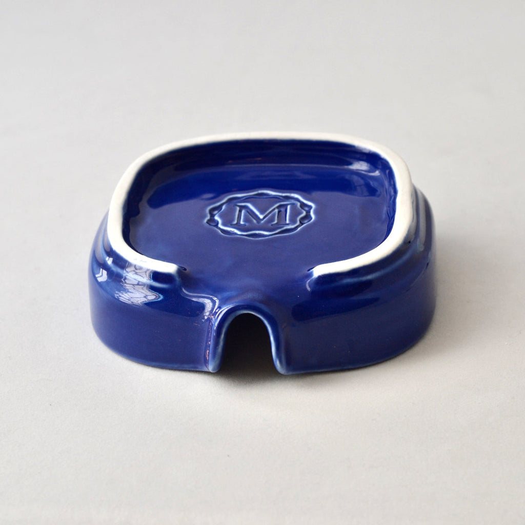 Cobalt blue porcelain soapdish with embossed logo on the base