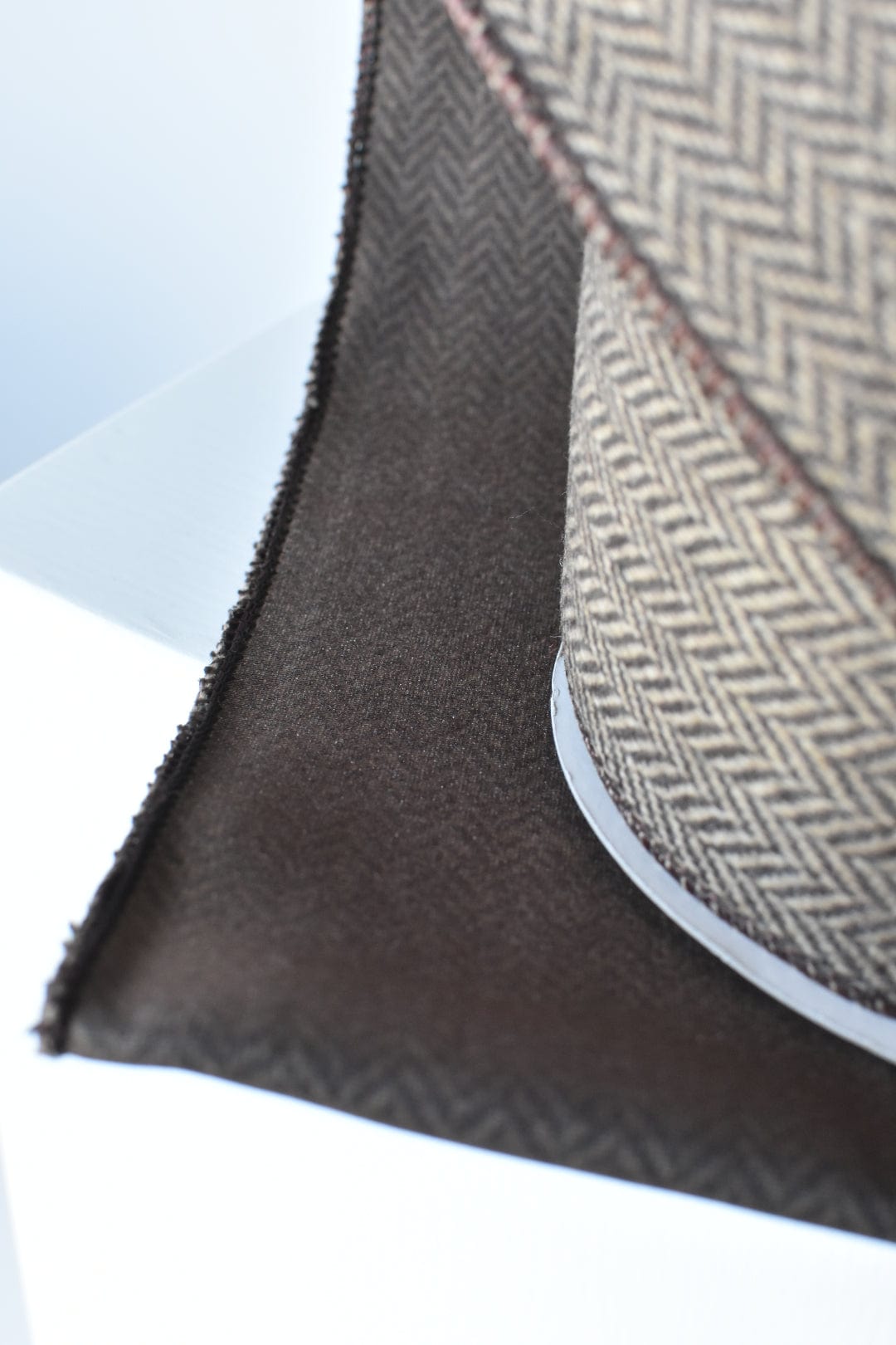 Woven herringbone ribbon with dark brown reverse side and stitched brown edge