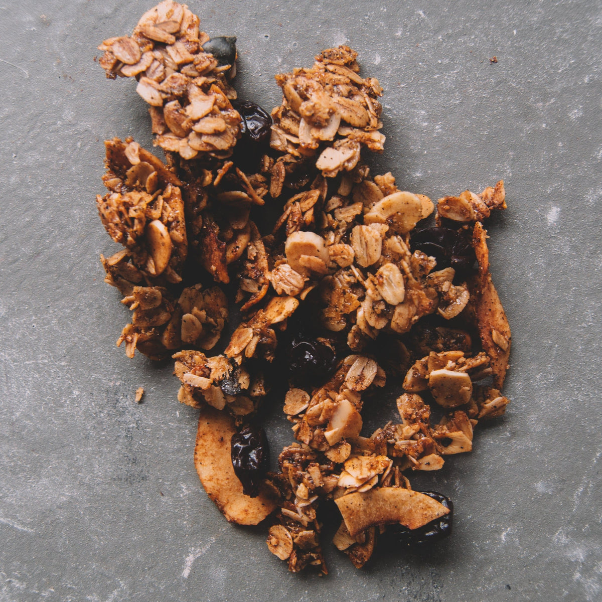 Vanilla bean granola clusters with visible dried cherry pieces