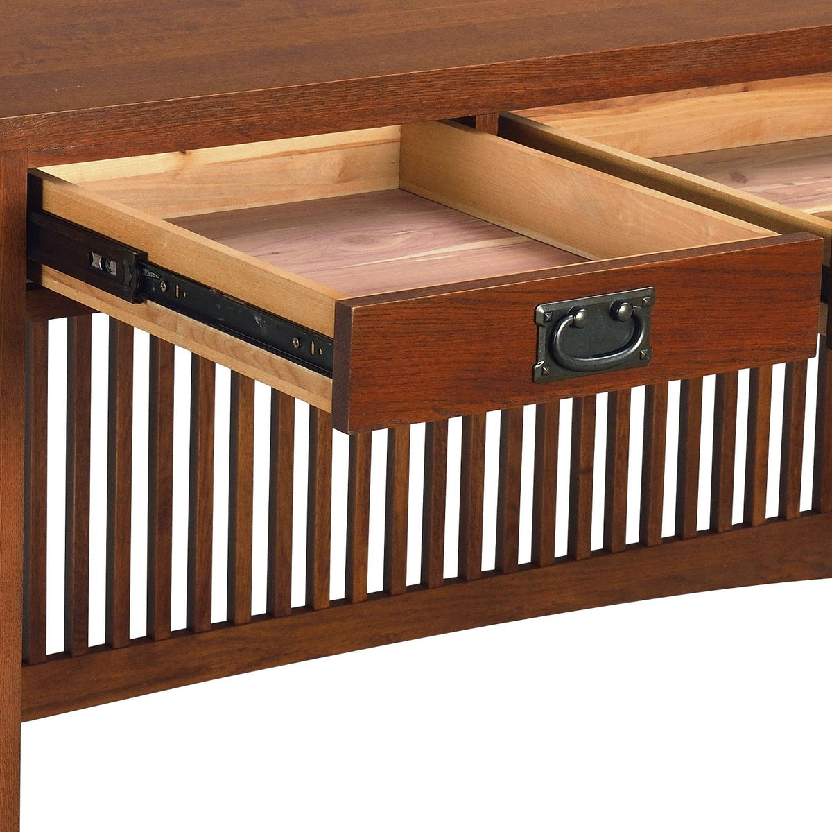 Open drawer of wood library desk with black hardware and slatted front paneling.