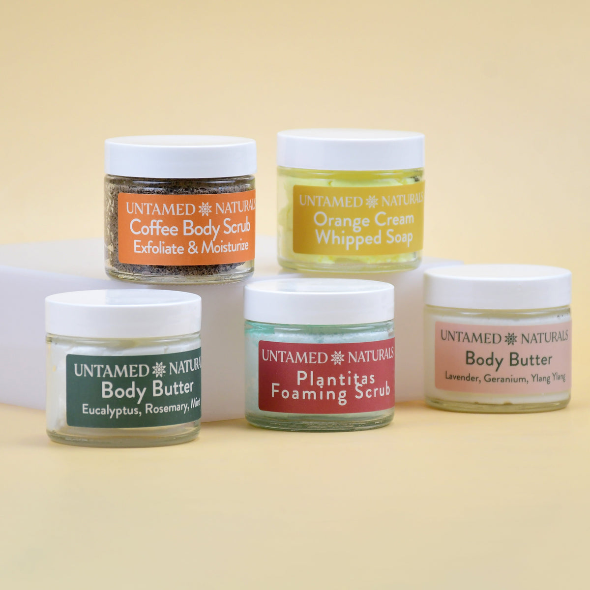 Body care jars set with labels: coffee body scrub, orange whipped soap, body butter