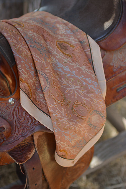Dusty rose wild rag scarf on leather saddle, paisley and floral patterned fabric