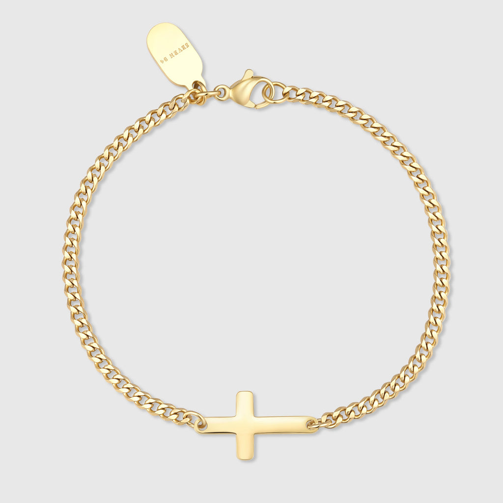 Gold cross bracelet with a small cross charm and linked chain
